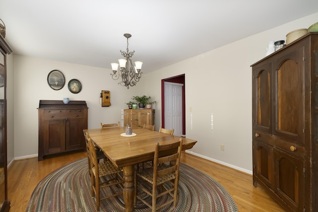 dining room with a notable chandelier and light hardwood / wood-style flooring