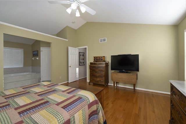 bedroom with ceiling fan, wood-type flooring, and lofted ceiling