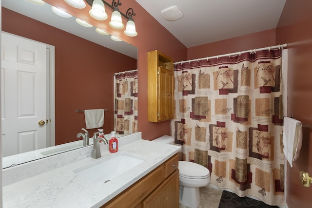 bathroom with vanity, tile patterned flooring, toilet, and walk in shower