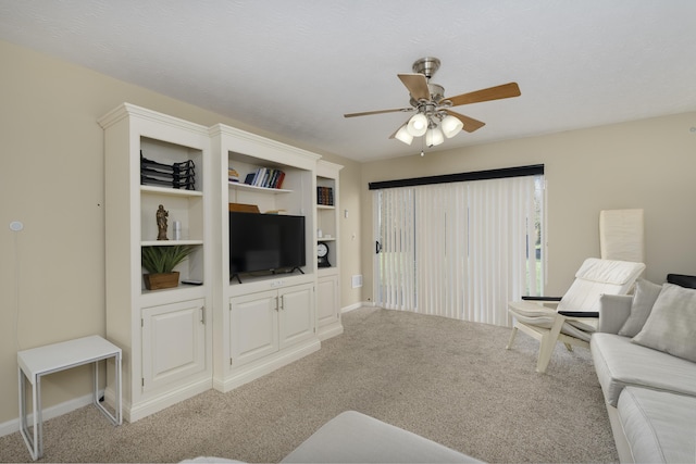 carpeted living room with ceiling fan