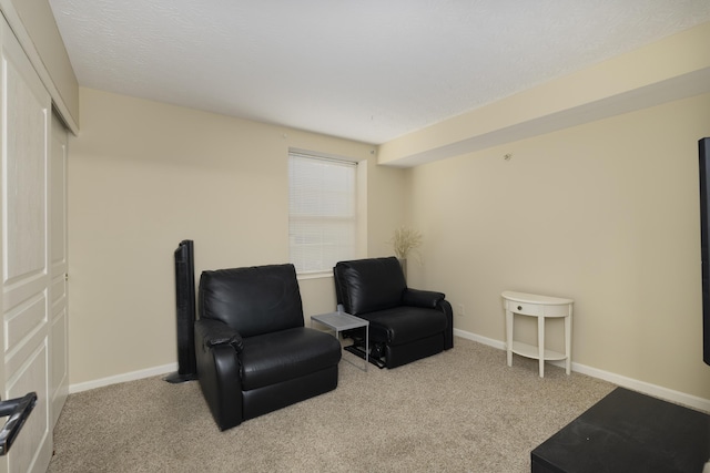 sitting room featuring light colored carpet