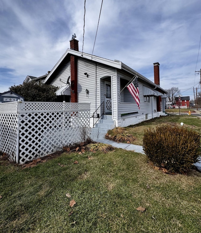 bungalow-style home with a front lawn