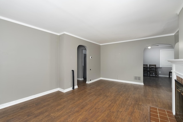 unfurnished room featuring dark wood-type flooring and ornamental molding