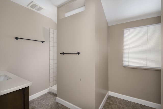 bathroom with walk in shower, tile patterned floors, and vanity