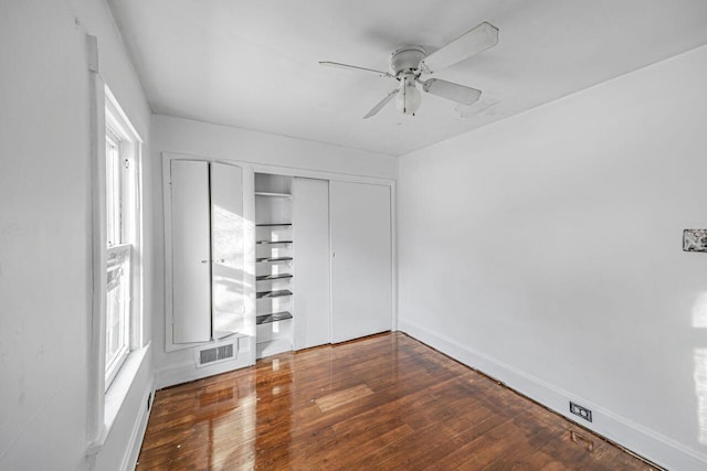 empty room with dark wood-type flooring and ceiling fan