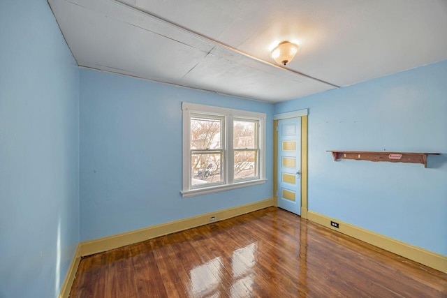 spare room with wood-type flooring