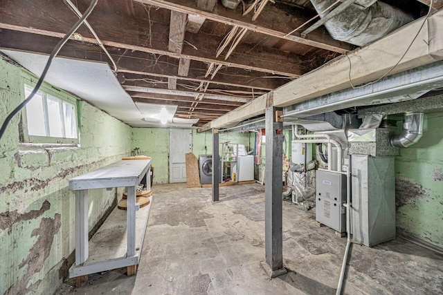 basement with heating unit and independent washer and dryer