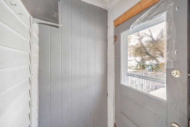 doorway featuring wood walls