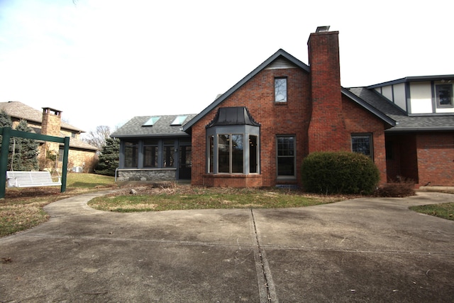 back of house featuring a sunroom