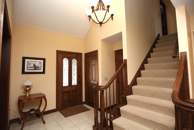 tiled entrance foyer featuring vaulted ceiling and a notable chandelier