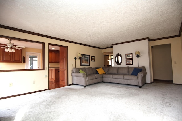 unfurnished living room featuring crown molding, carpet flooring, ceiling fan, and a textured ceiling