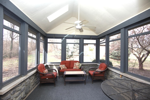 sunroom featuring ceiling fan and vaulted ceiling with skylight