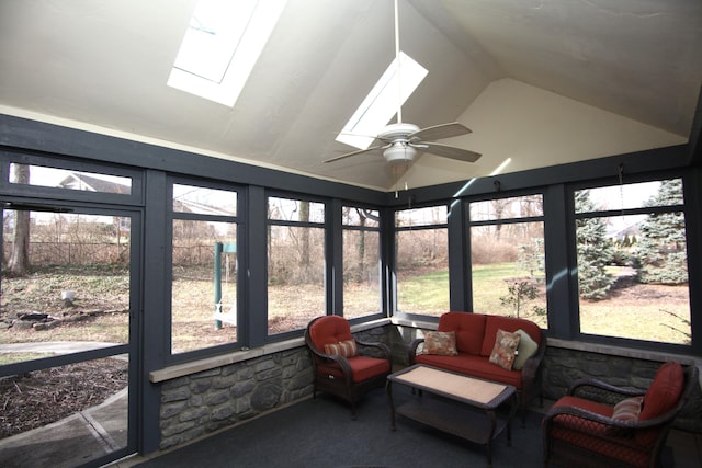 sunroom featuring ceiling fan and lofted ceiling with skylight