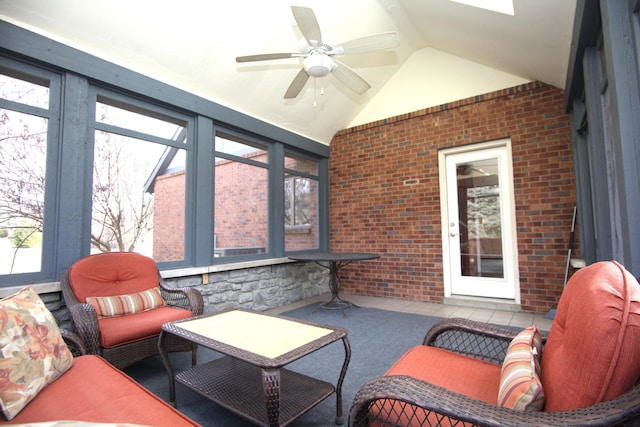 sunroom featuring lofted ceiling and ceiling fan