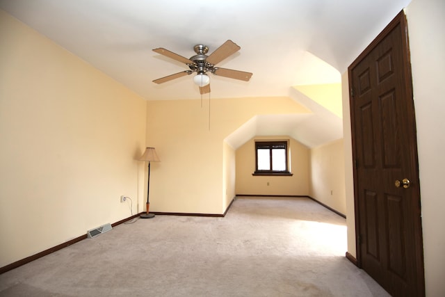 bonus room with light carpet, lofted ceiling, and ceiling fan