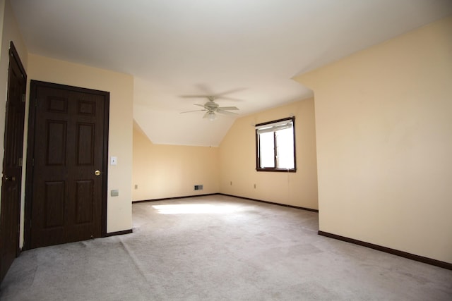 additional living space featuring light carpet, lofted ceiling, and ceiling fan