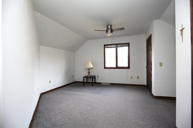 bonus room with lofted ceiling, dark carpet, and ceiling fan