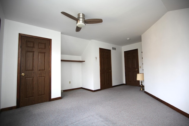 unfurnished bedroom featuring ceiling fan, lofted ceiling, carpet floors, and a closet