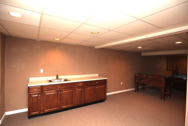 bar with a drop ceiling, sink, and carpet floors