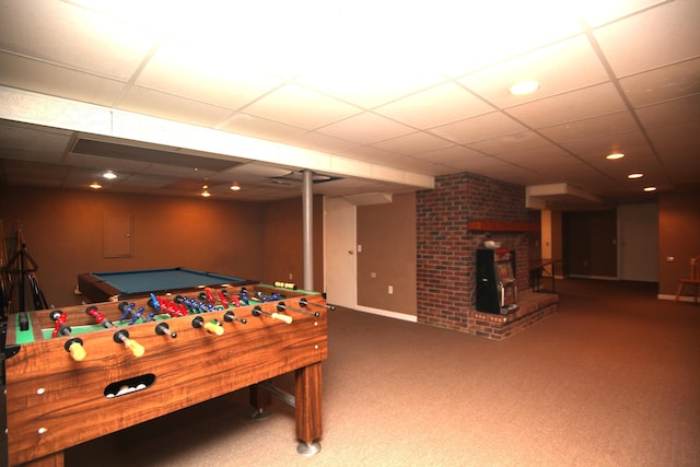 recreation room with carpet and a paneled ceiling