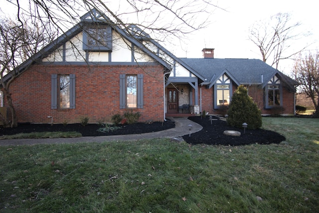 english style home with a front lawn