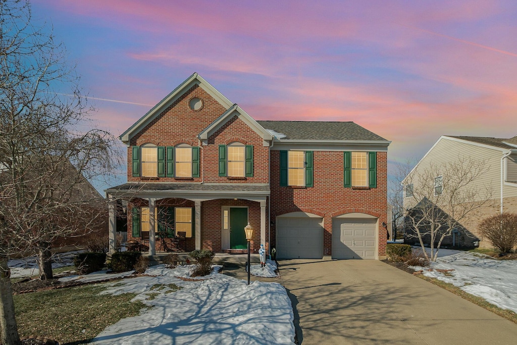 view of front of property featuring a garage and covered porch