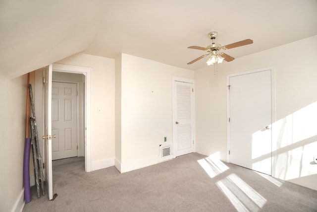 interior space featuring ceiling fan and vaulted ceiling