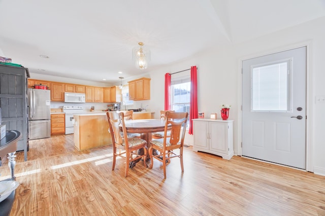 dining room with light wood finished floors and recessed lighting