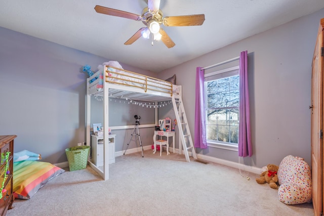 carpeted bedroom with visible vents, baseboards, and a ceiling fan