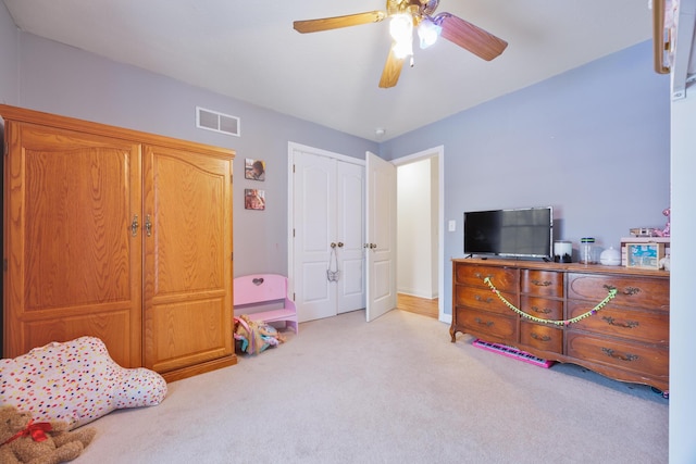 bedroom with a closet, visible vents, carpet floors, and ceiling fan