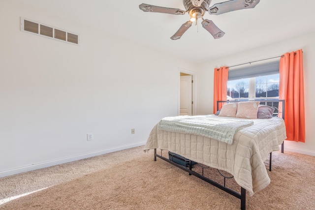 carpeted bedroom featuring visible vents, baseboards, and ceiling fan