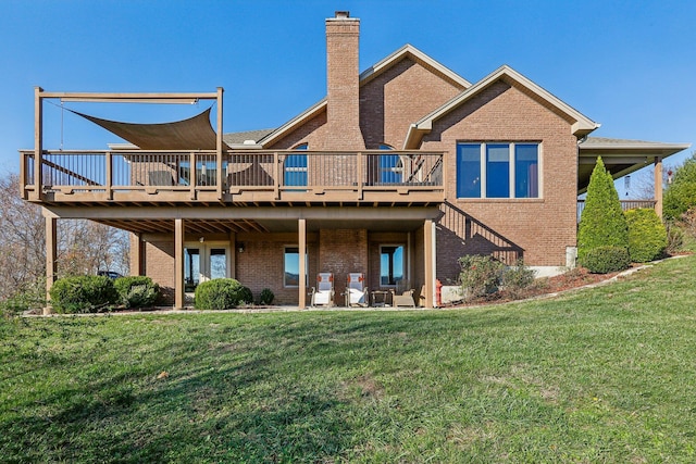 back of property featuring a deck and a lawn