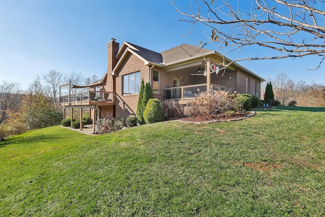 view of side of home featuring a wooden deck, a lawn, and ceiling fan