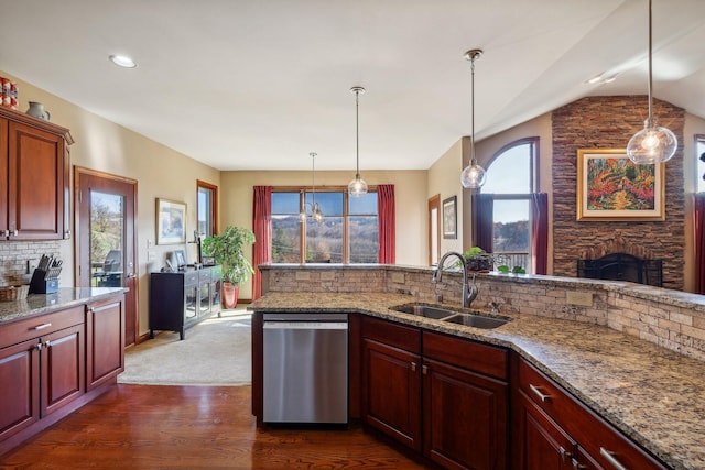 kitchen featuring dishwasher, sink, and light stone counters