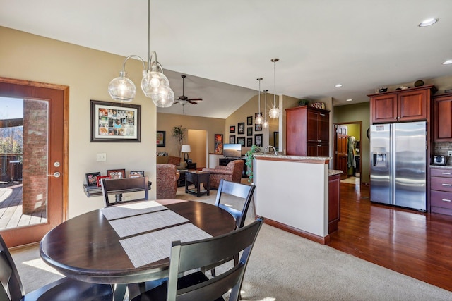 dining room with lofted ceiling, dark wood-type flooring, and ceiling fan