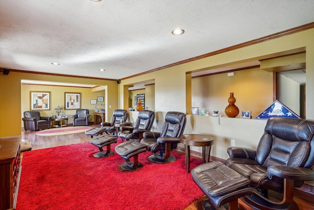 living room featuring ornamental molding, hardwood / wood-style floors, and a textured ceiling