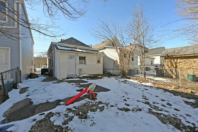 view of snow covered rear of property