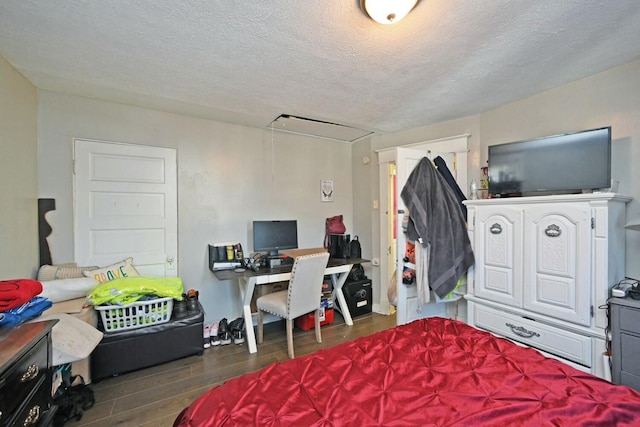 bedroom with dark wood-type flooring and a textured ceiling