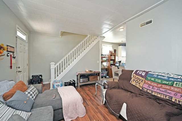 living room with dark wood-type flooring and a wealth of natural light