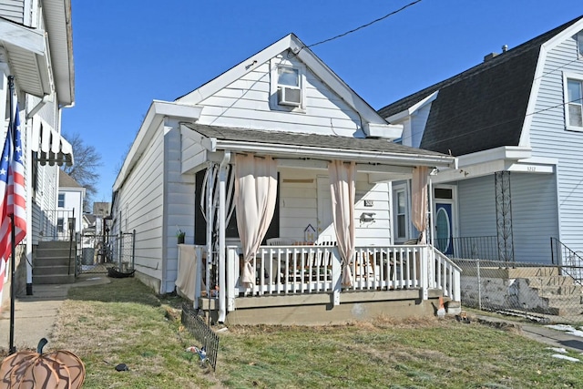 bungalow-style house with a front yard and a porch