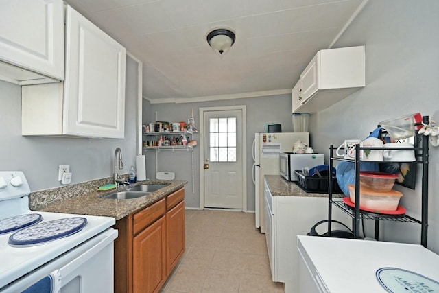 kitchen featuring electric stove, light tile patterned floors, sink, and white cabinets