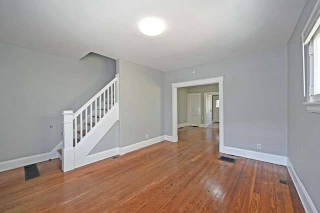 spare room featuring wood-type flooring