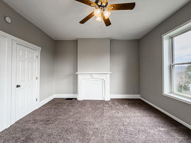 empty room featuring carpet floors and ceiling fan