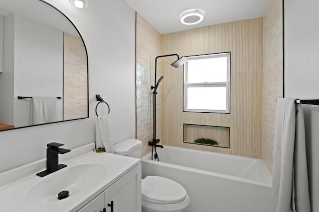 full bathroom featuring vanity, toilet, and tiled shower / bath combo