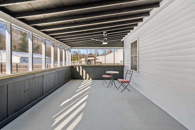 sunroom featuring beamed ceiling