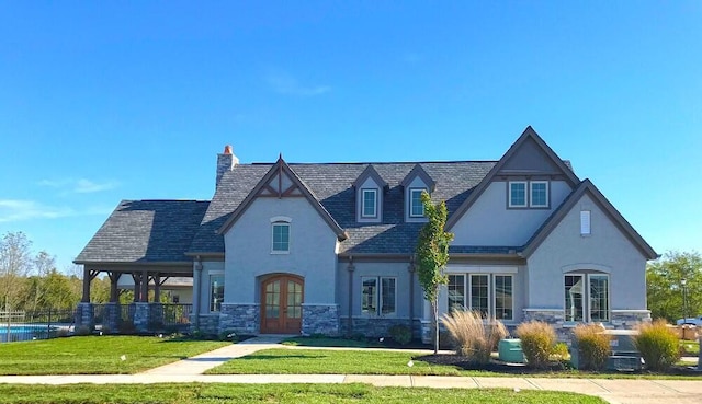 exterior space featuring french doors and a front yard