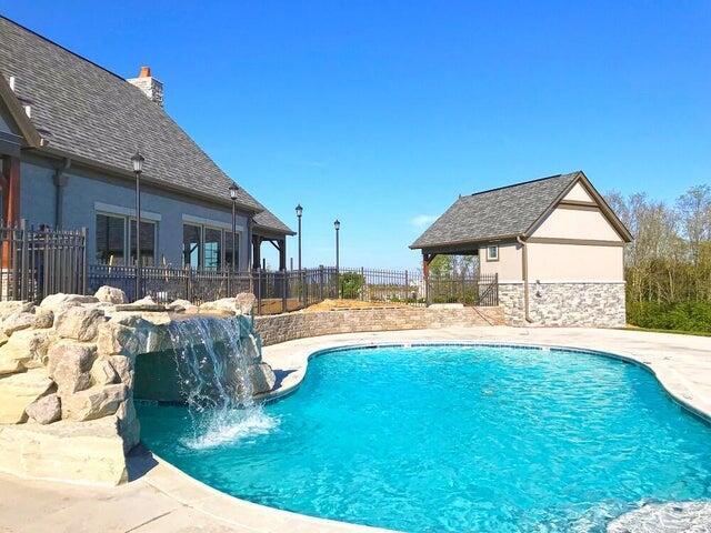 view of pool with a patio and pool water feature