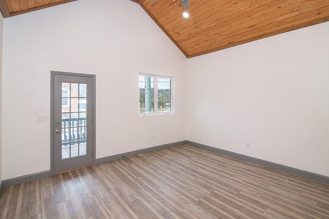 empty room featuring wood ceiling, dark hardwood / wood-style flooring, and high vaulted ceiling