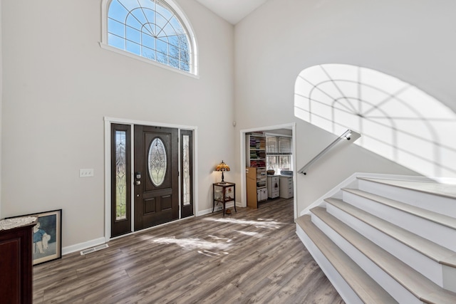 15027 Madison Pike, Morning View, KY 41063 - entryway featuring plenty of natural light, a towering ceiling, wood finished floors, stairs, and baseboards