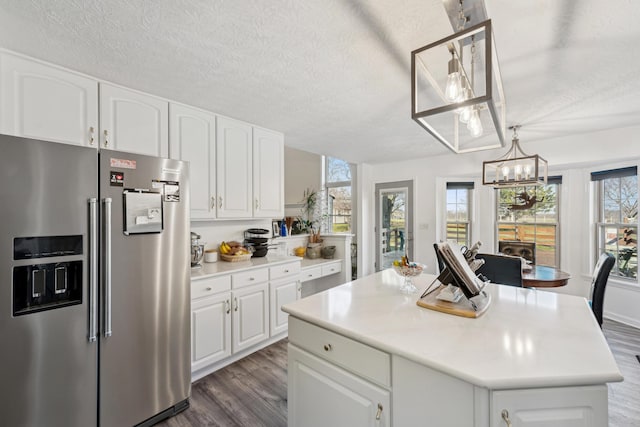 15027 Madison Pike, Morning View, KY 41063 - kitchen with high quality fridge, dark wood-type flooring, a chandelier, white cabinetry, and a textured ceiling